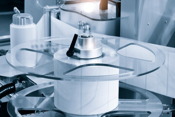 Fragment of the conveyor of sticking labeling machine. Abstract industrial background.