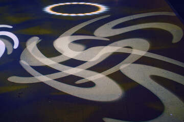 Abstract geometric shapes background of the movement of light and shadow on the asphalt