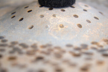 Close-up of a rusting metal drum cymbal
