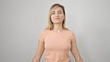 Fototapeta premium Young blonde woman smiling confident standing over isolated white background