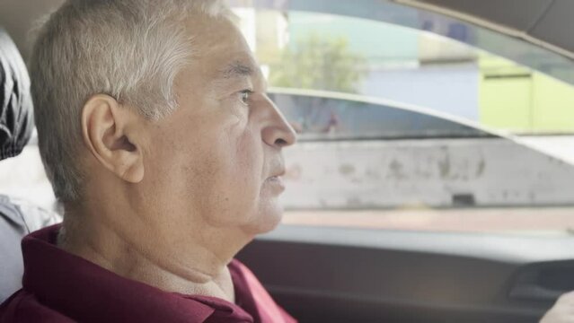 Seasoned Driver, Elderly Taxi and App Driver Navigates São Paulo Suburbs on Sunny Day, Engaging with Passenger