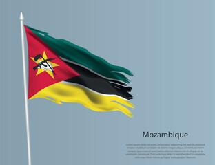 Ragged national flag of Mozambique. Wavy torn fabric on blue background