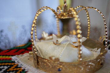 Church crown and gold wedding rings. Church wedding.