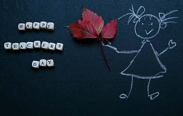 chalk drawing of a girl with an autumn leaf and the inscription in English Happy Teacher's Day