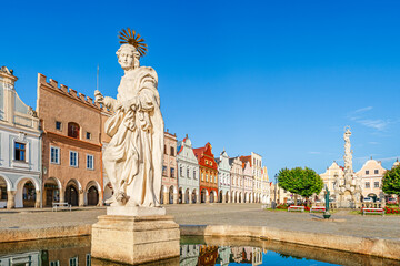 Telč, Czech Republic - 8 July 2023: Saint Margaret fountain and colorful houses on the main square in the of town of Telč - 662363514