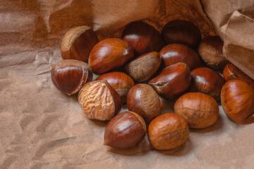 Sweet Chestnuts Top view. Copyspace. Pile of ripe chestnuts for food background..