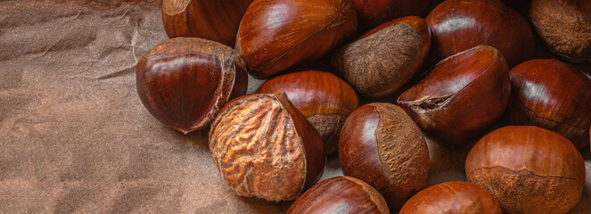 Sweet Chestnuts Top view. Copyspace. Pile of ripe chestnuts for food background..