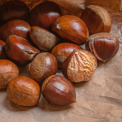 Sweet Chestnuts Top view. Copy space. Pile of ripe chestnuts for food background closeup.