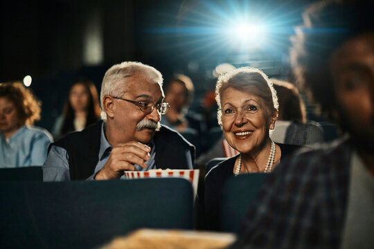 Senior Caucasian couple watching a movie in the movie theater