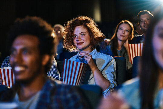 Young woman watching a movie in a cinema