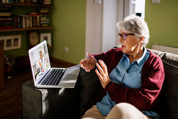Senior Caucasian woman consulting her doctor on a video call on the laptop at home