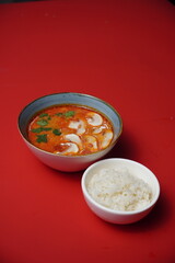 tom yum with rice and mushrooms, spicy soup, asian food