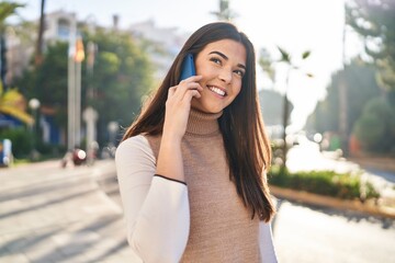 Young beautiful hispanic woman smiling confident talking on the smartphone at street © Krakenimages.com