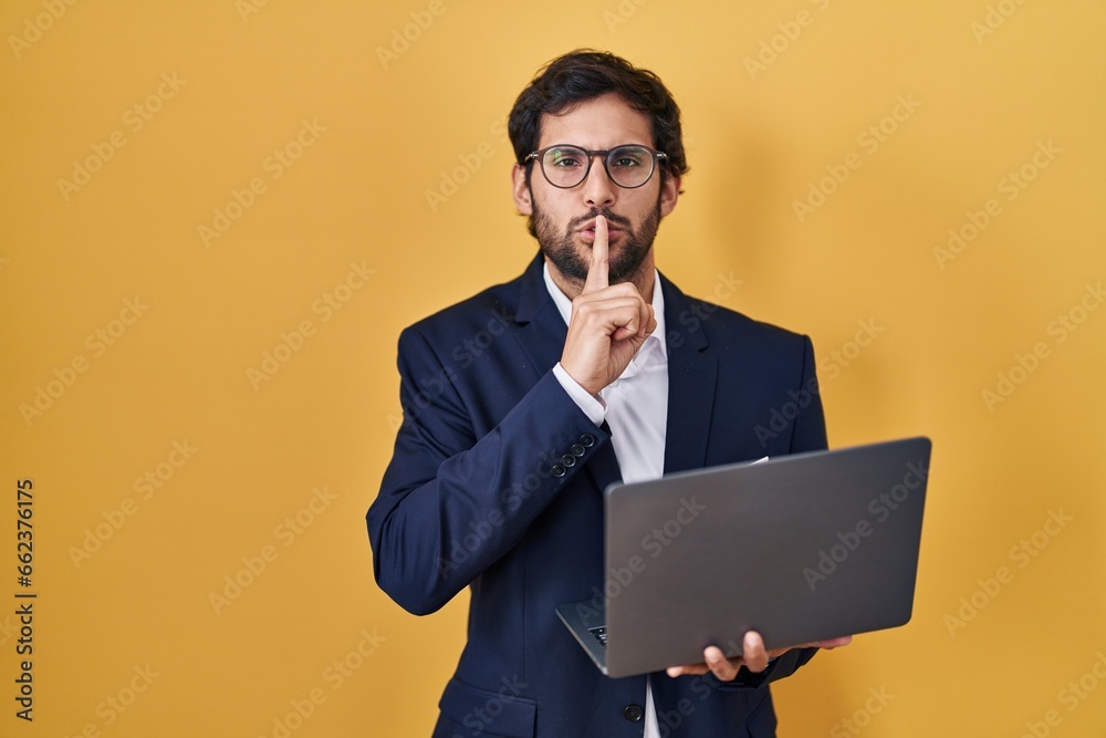 Sticker handsome latin man working using computer laptop asking to be quiet with finger on lips. silence and