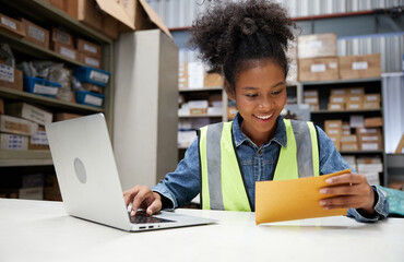 factory worker reading and looking at envelope in the office or warehouse storage