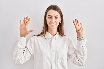 Young caucasian woman standing over isolated background showing and pointing up with fingers number...