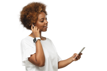Young african american woman listening to music via wireless earphones, using music streaming service app on the phone