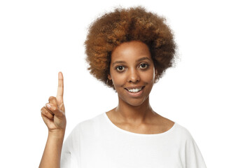 Happy young african woman in white t-shirt pointing up with her finger