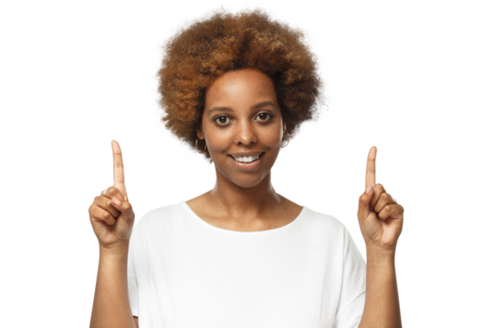 Happy young african woman in white t-shirt pointing up with both hands