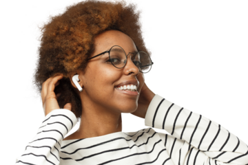 Smiling african american woman wearing glasses, touching her afro hair, listening to music via wireless earphones