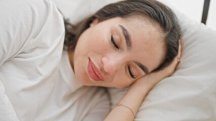 Young beautiful hispanic woman lying on bed sleeping at bedroom