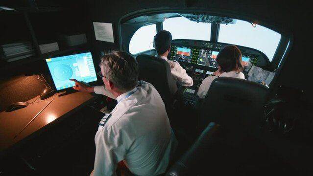Instructor and pilots in professional flight simulator during flight