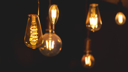 Retro light bulbs hanging on a dark background. Electricity, Vintage