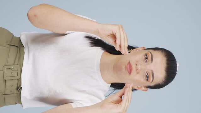Vertical Video of Woman making chatty expressions looking at camera.