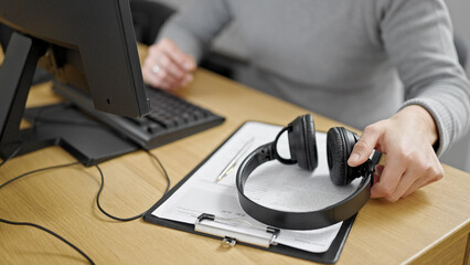 Hispanic man holding headphones at office