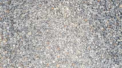  Closeup shot of a gravel road showcasing intricate pebble patterns.
