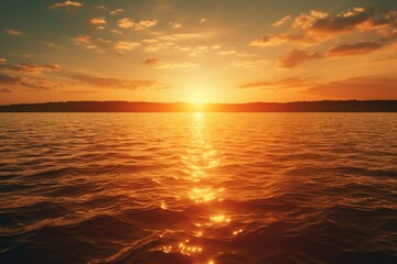 Fototapeta premium A beautiful sunset over a calm body of water. Perfect for capturing the serene beauty of nature.