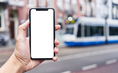 Man holding smartphone showing white blank screen at street