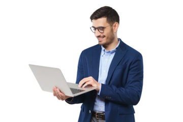 Young modern businessman wearing blue suit, standing with open laptop in hands, surfing the internet with smile