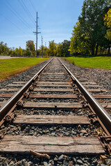 Obraz premium Railway train tracks in the golden sunlight of autumn with colorful character