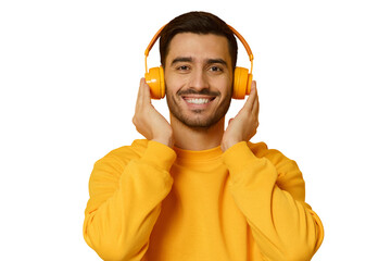 Smiling young man listening music, wearing yellow wireless headphones and sweatshirt, enjoying...