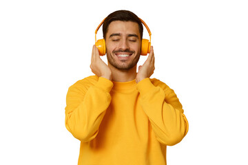 Smiling young man listening music, wearing yellow wireless headphones and sweatshirt, enjoying...