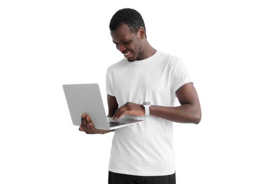 Young handsome african american man standing, holding laptop and watching media with happy smile, sharing web content