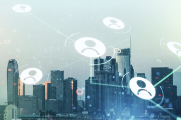 Double exposure of abstract virtual social network icons on Los Angeles city skyscrapers background. Marketing and promotion concept