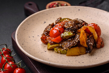 Warm salad with veal, tomatoes, peppers, zucchini, sesame, salt, spices and herbs