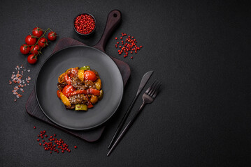 Warm salad with veal, tomatoes, peppers, zucchini, sesame, salt, spices and herbs