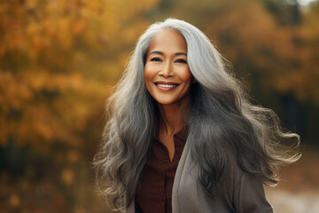 Naklejka premium Generative AI technology picture of gorgeous grey haired woman walking autumn park