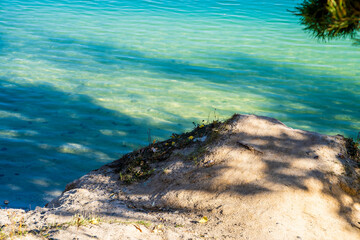 Sandy beach, white sand, Tarawa. Blue water, lake. Sunny day. Autumn.