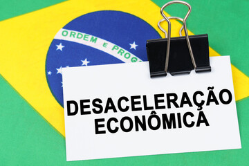 On the flag of Brazil lies a business card with the inscription - economic slowdown