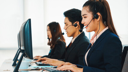 Business people wearing headset working in office to support remote customer or colleague. Call center, telemarketing, customer support agent provide service on telephone video conference call. Jivy - obrazy, fototapety, plakaty
