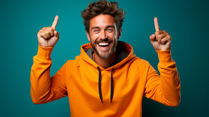 young handsome man with beard wearing winter jacket and sunglasses over isolated background very happy and excited for winner expression with arms raised, smiling and screaming for - obrazy, fototapety, plakaty