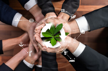 Business partnership holding plant together with recycle icon symbolize ESG sustainable environment...