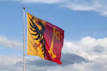 Flag of Geneva waving atop of its pole