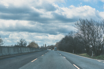forrest romantic road in cold winter foggy afternoon with traffic