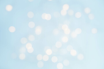 Abstract festive blue background on the theme of Christmas or New Year with bokeh in blurry focus. 