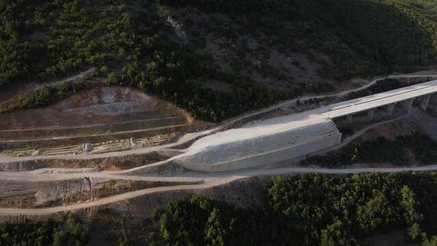 Highway bridge under construction. Aerial view of nes road. Freeway being built on a mountain terrain..